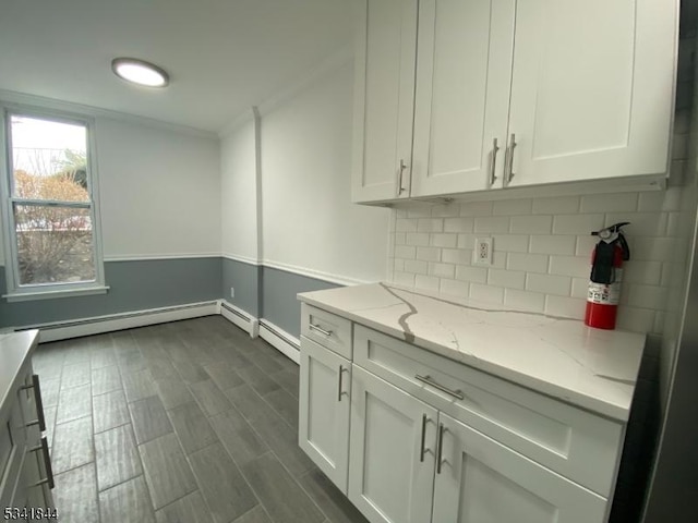 kitchen with dark wood-style floors, white cabinetry, decorative backsplash, and light stone countertops