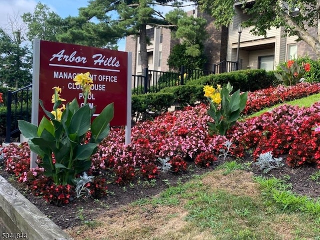 community / neighborhood sign with fence