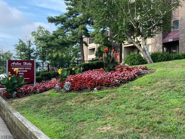 community / neighborhood sign with a yard