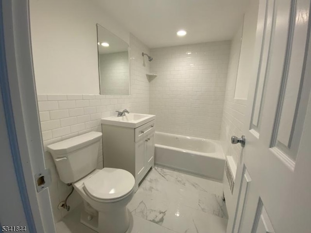 full bathroom with toilet, marble finish floor, vanity, shower / washtub combination, and tile walls