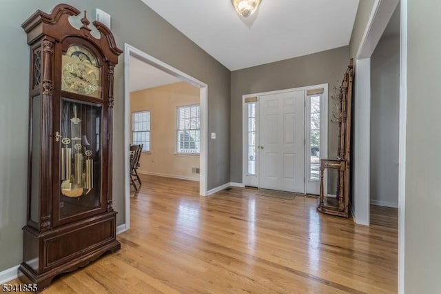 foyer featuring light wood-style flooring and baseboards