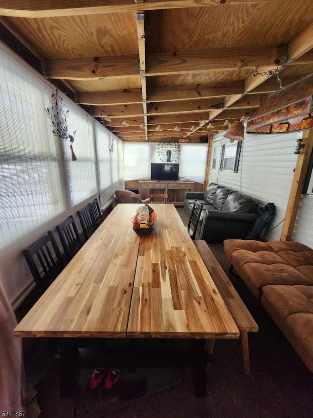 dining space featuring beam ceiling and wooden ceiling