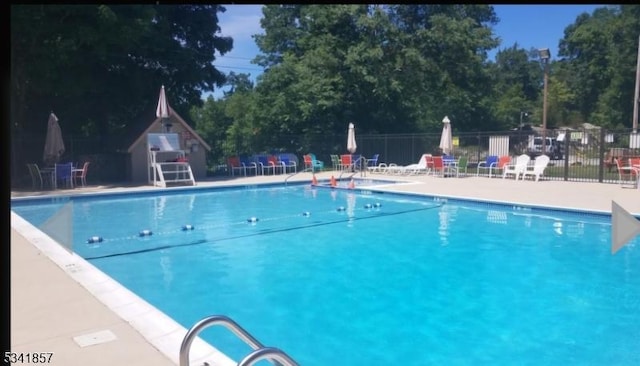 community pool featuring a patio area and fence