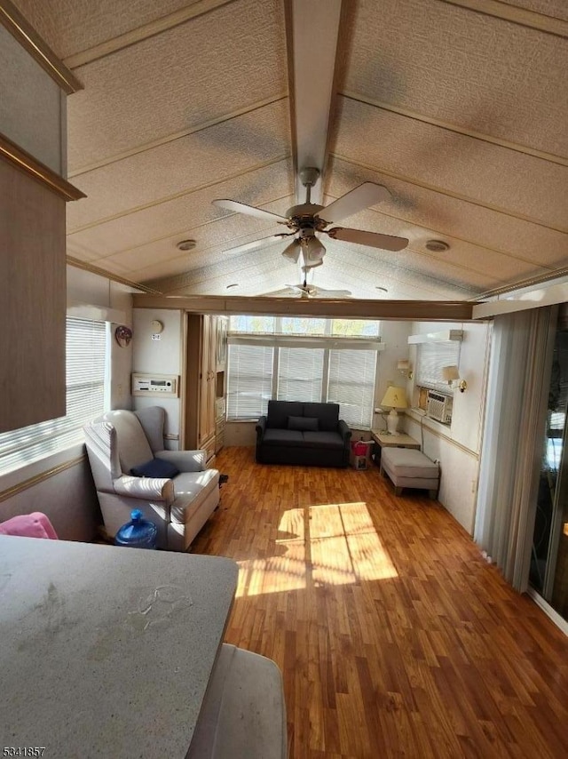 unfurnished sunroom with ceiling fan and vaulted ceiling