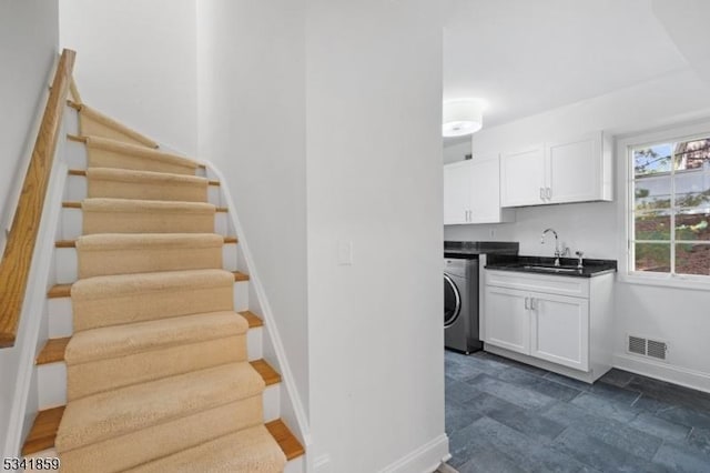 interior space with washer / clothes dryer, visible vents, and baseboards