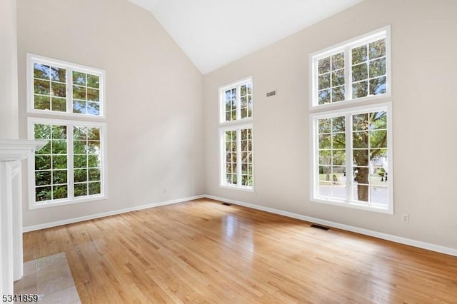 interior space featuring high vaulted ceiling, visible vents, and light wood-style floors