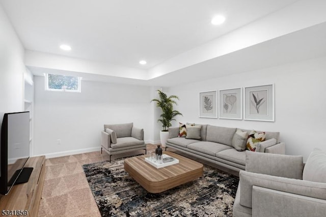 living room featuring recessed lighting, light colored carpet, and baseboards