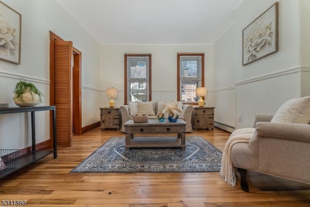 23 Swan St, Lambertville City, NJ 08530 - living room featuring a baseboard heating unit, wood finished floors, and wainscoting
