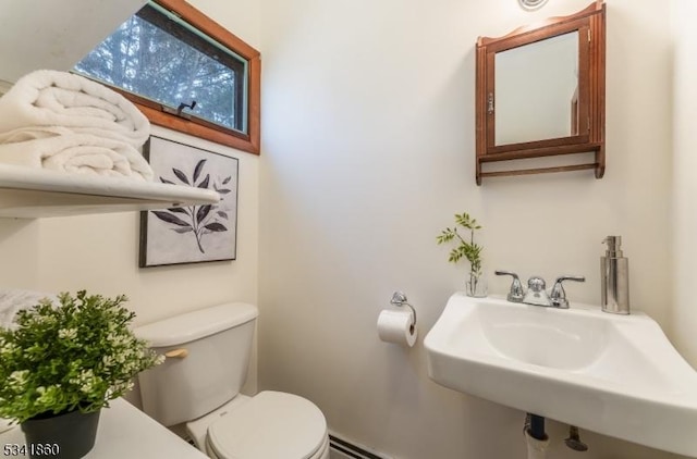 half bathroom featuring a sink and toilet