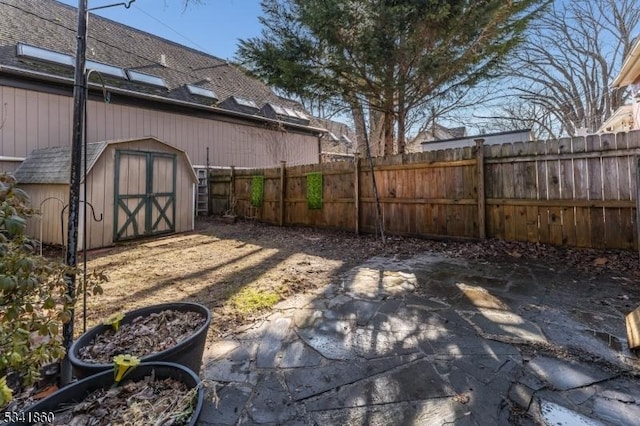 view of yard featuring a fenced backyard, an outdoor structure, and a shed