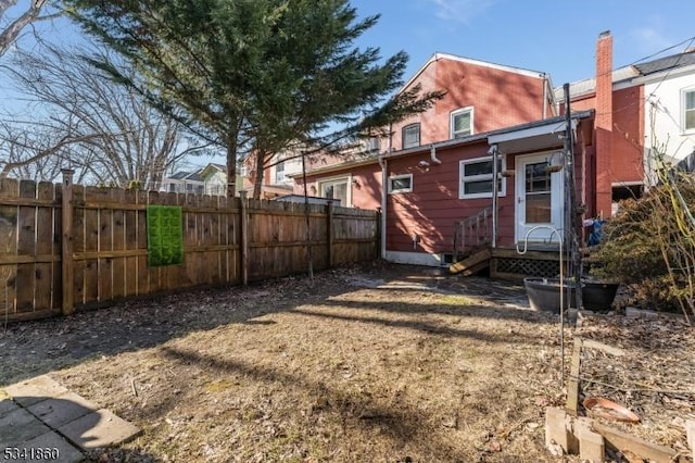 rear view of house featuring fence