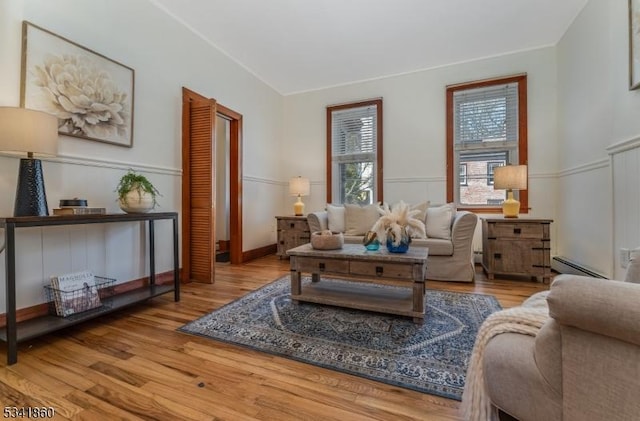 sitting room featuring baseboard heating and wood finished floors