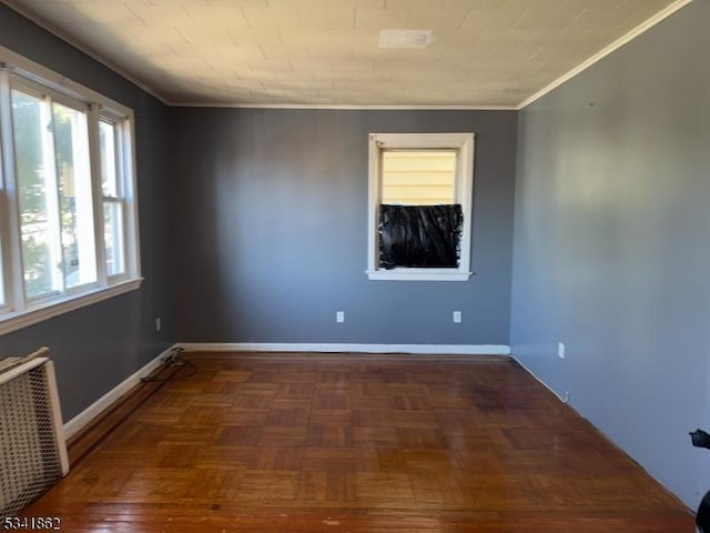 unfurnished room featuring radiator, baseboards, and ornamental molding