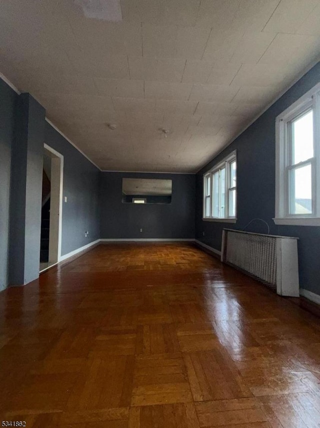 interior space with radiator heating unit, a wall mounted AC, and baseboards