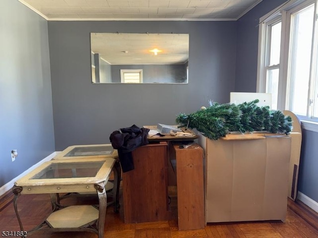 interior space with crown molding, baseboards, and wood finished floors