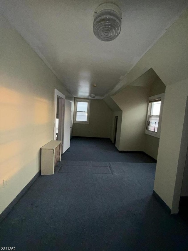 bonus room with carpet and baseboards