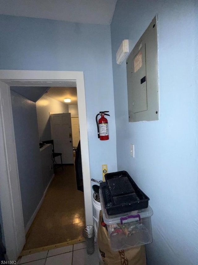 hallway featuring tile patterned flooring and electric panel