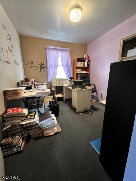 office featuring dark colored carpet and cooling unit