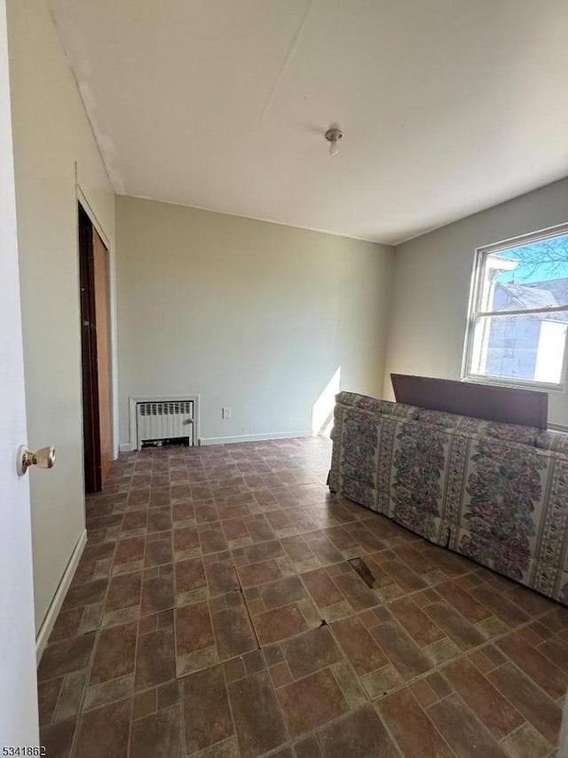 interior space with baseboards and radiator heating unit