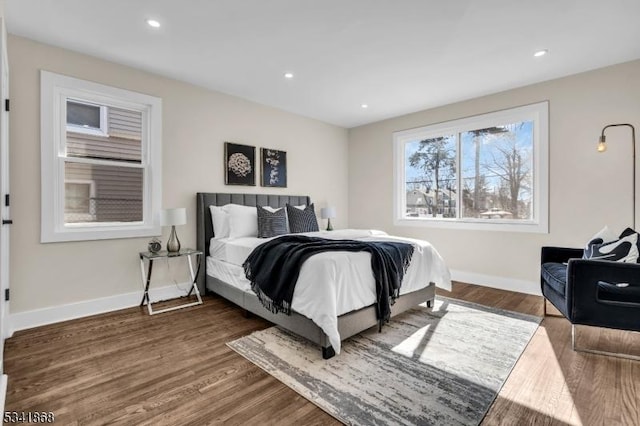 bedroom with dark wood-style floors, baseboards, and recessed lighting