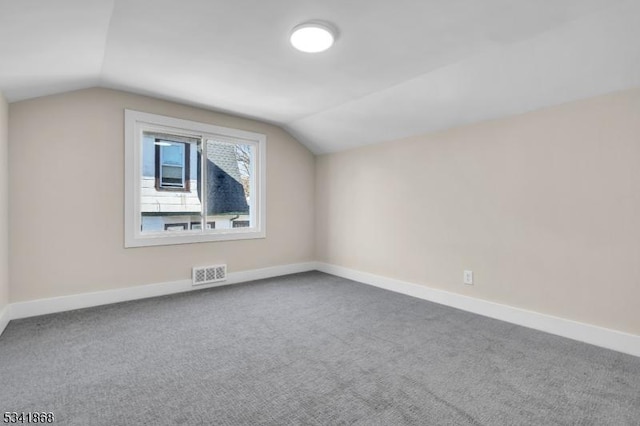 bonus room featuring baseboards, visible vents, and vaulted ceiling