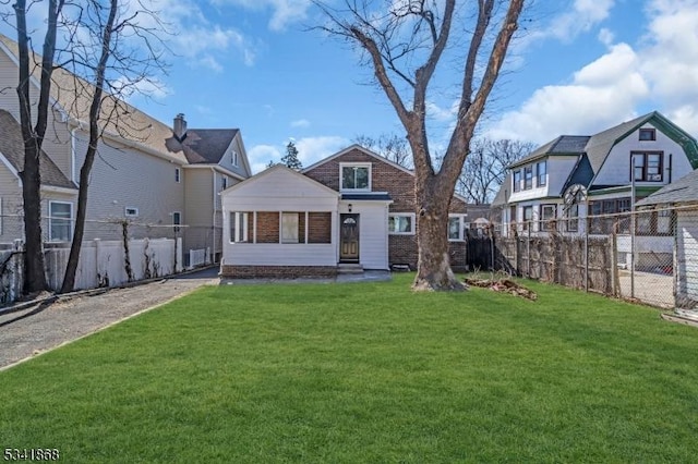 back of property featuring a fenced backyard and a yard