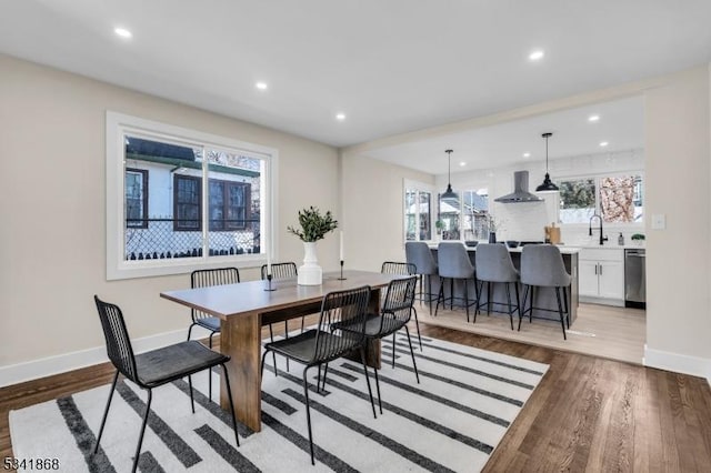 dining area with light wood finished floors, recessed lighting, and baseboards