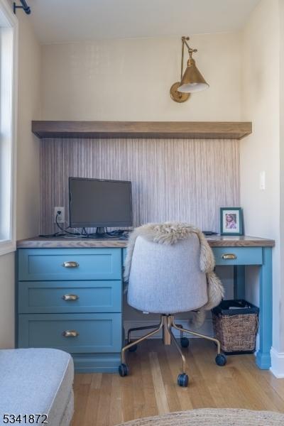 home office with light wood finished floors