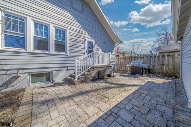 view of patio featuring fence