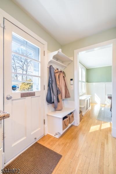 mudroom with light wood-style floors and wainscoting