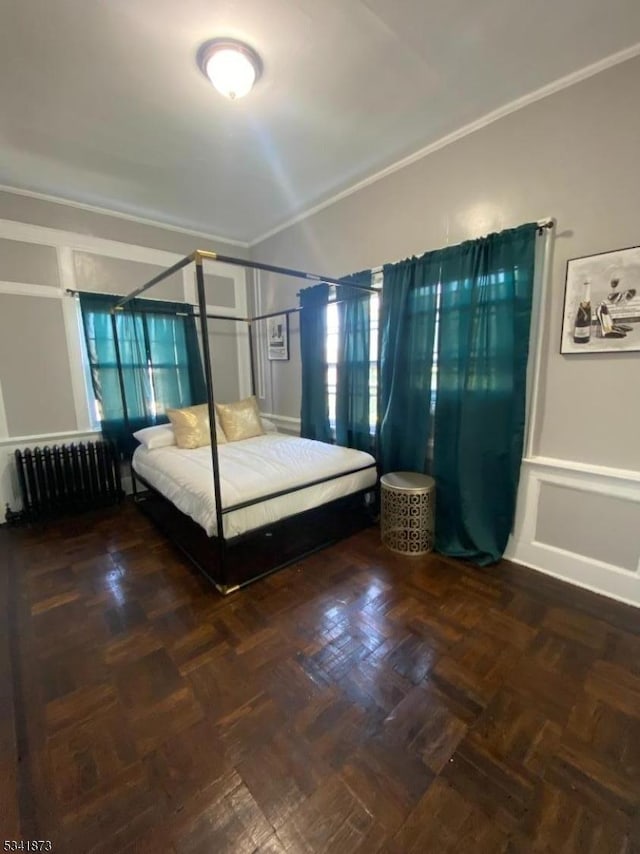 unfurnished bedroom with radiator and crown molding