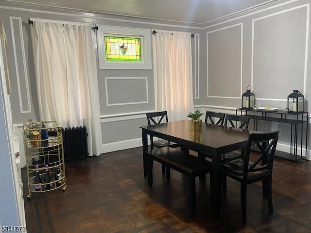 dining space with a decorative wall and radiator heating unit