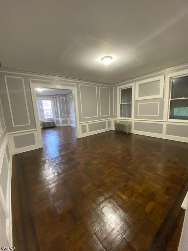 interior space with radiator and a decorative wall