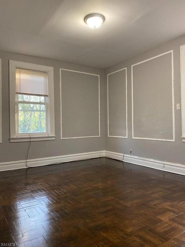 spare room with baseboards