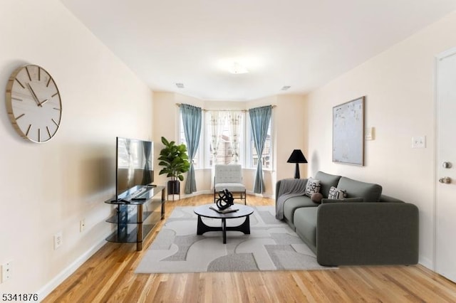 living area with wood finished floors and baseboards