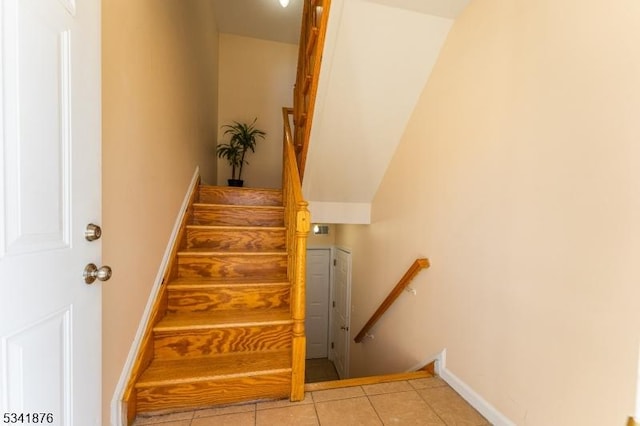 staircase with tile patterned flooring, visible vents, and baseboards