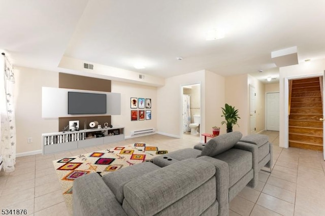 living room featuring visible vents, a baseboard heating unit, light tile patterned flooring, baseboards, and stairs