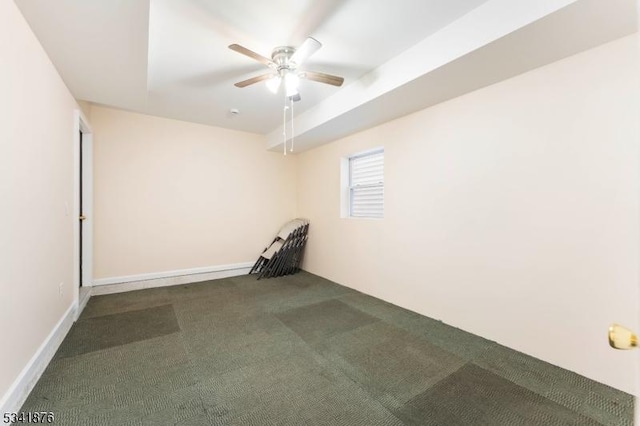 carpeted spare room with a ceiling fan