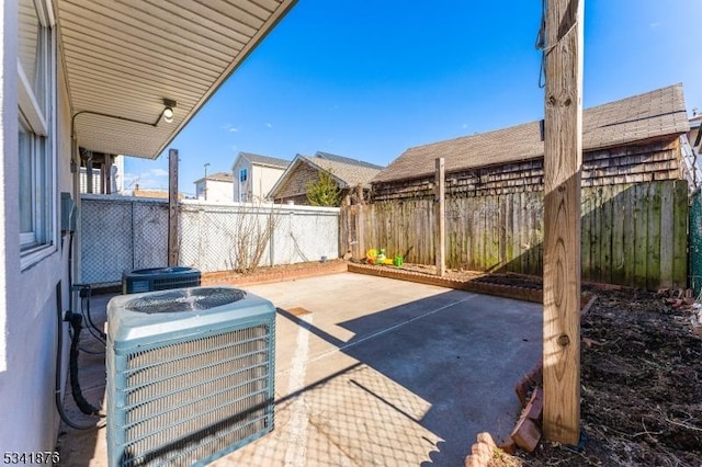 view of patio featuring cooling unit and a fenced backyard