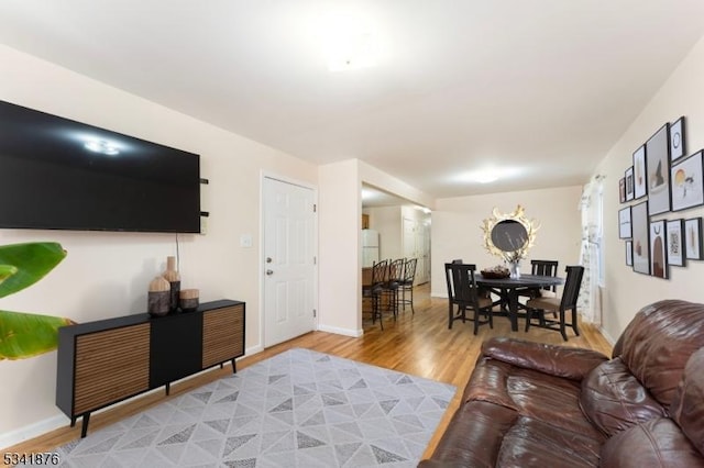 living area featuring wood finished floors and baseboards