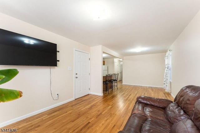 living area with wood finished floors and baseboards