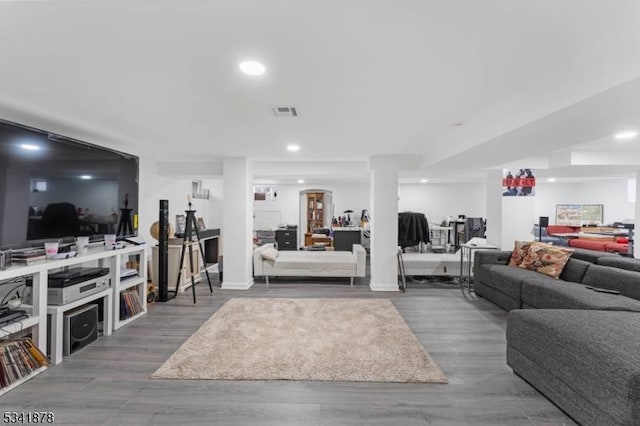 living room with visible vents, wood finished floors, and recessed lighting