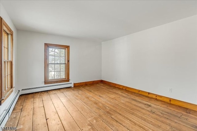 empty room with light wood-type flooring, baseboards, baseboard heating, and a baseboard radiator