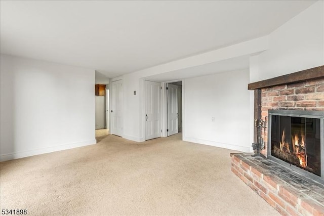 unfurnished living room with a brick fireplace, light carpet, and baseboards