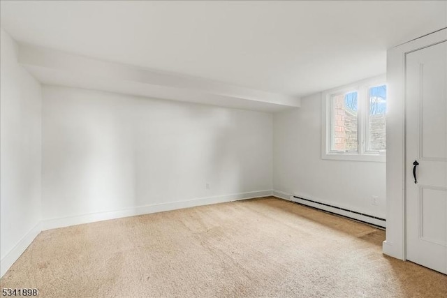 carpeted spare room featuring a baseboard radiator and baseboards