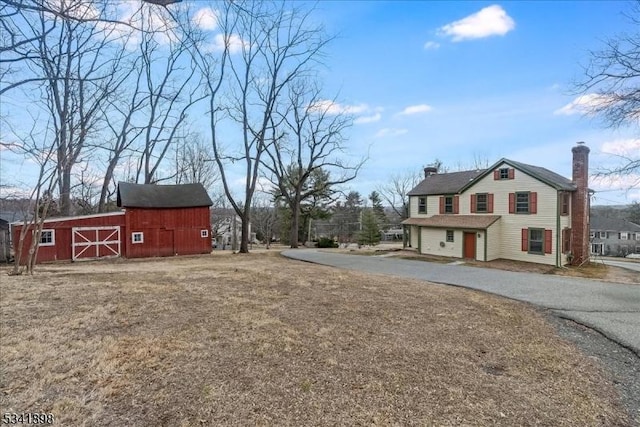 view of yard with a barn and an outbuilding