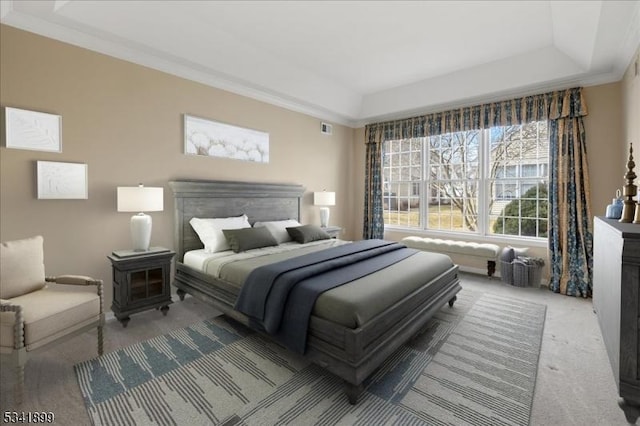 bedroom featuring crown molding, a tray ceiling, visible vents, and carpet floors