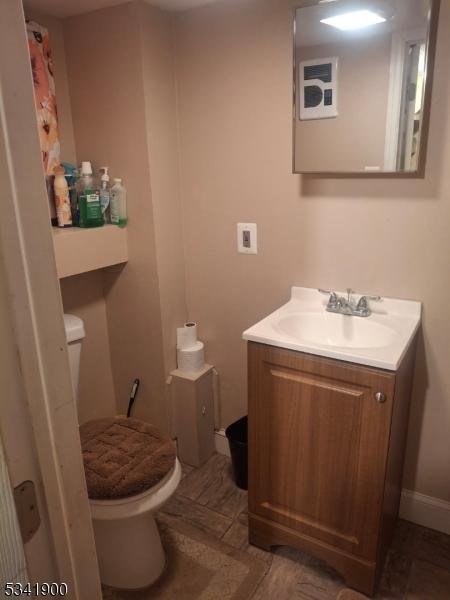 half bath with vanity and toilet