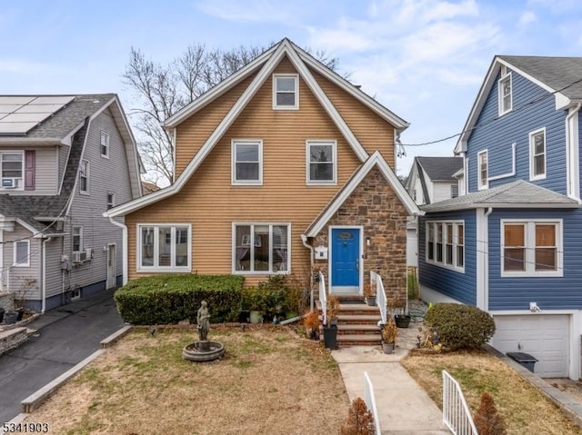 view of front of home featuring a garage and stone siding