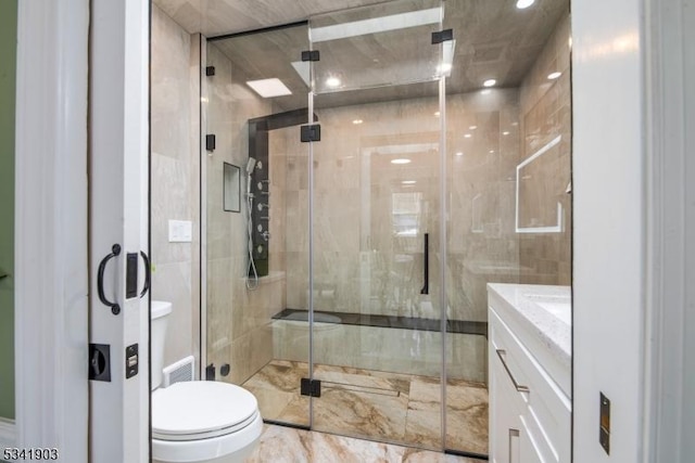 full bath with toilet, visible vents, a stall shower, and vanity